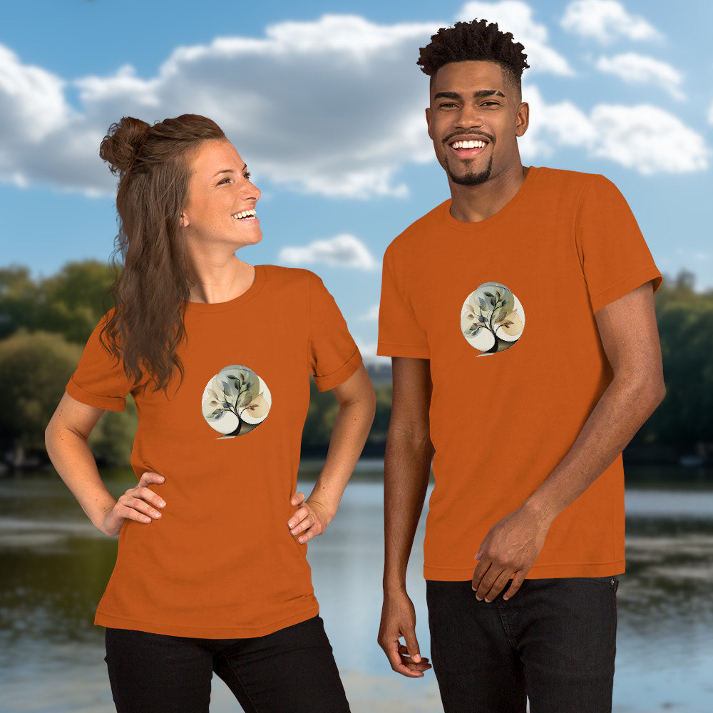 Essence of Nature - Elegant, stylized tree design with fluid curves and semi-transparent leaves in gentle earth-tone colors, set within a circular shape. Two Models with graphic printed on autumn-colored Unisex Staple T-Shirt Bella + Canvas 3001
