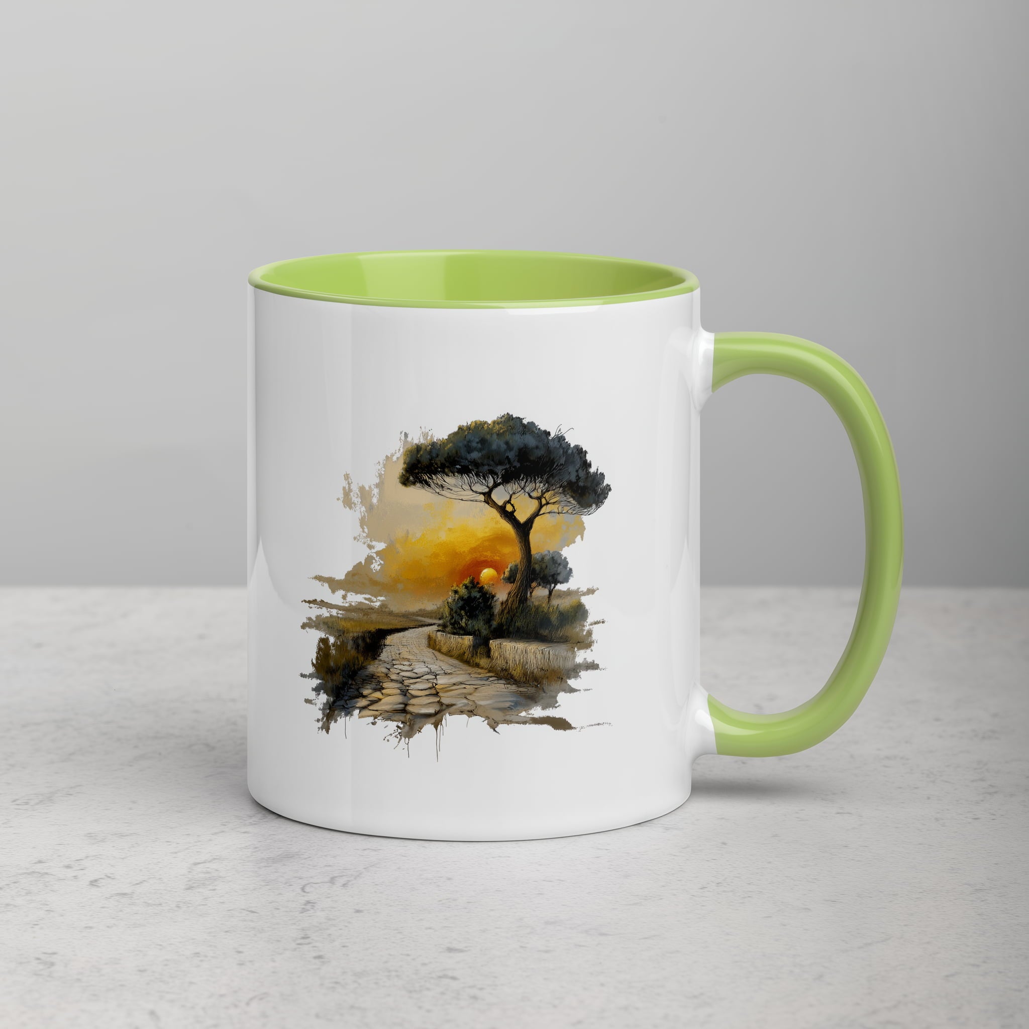 Close-up of the Sunset Path illustration on mug surface with green rim and handle.