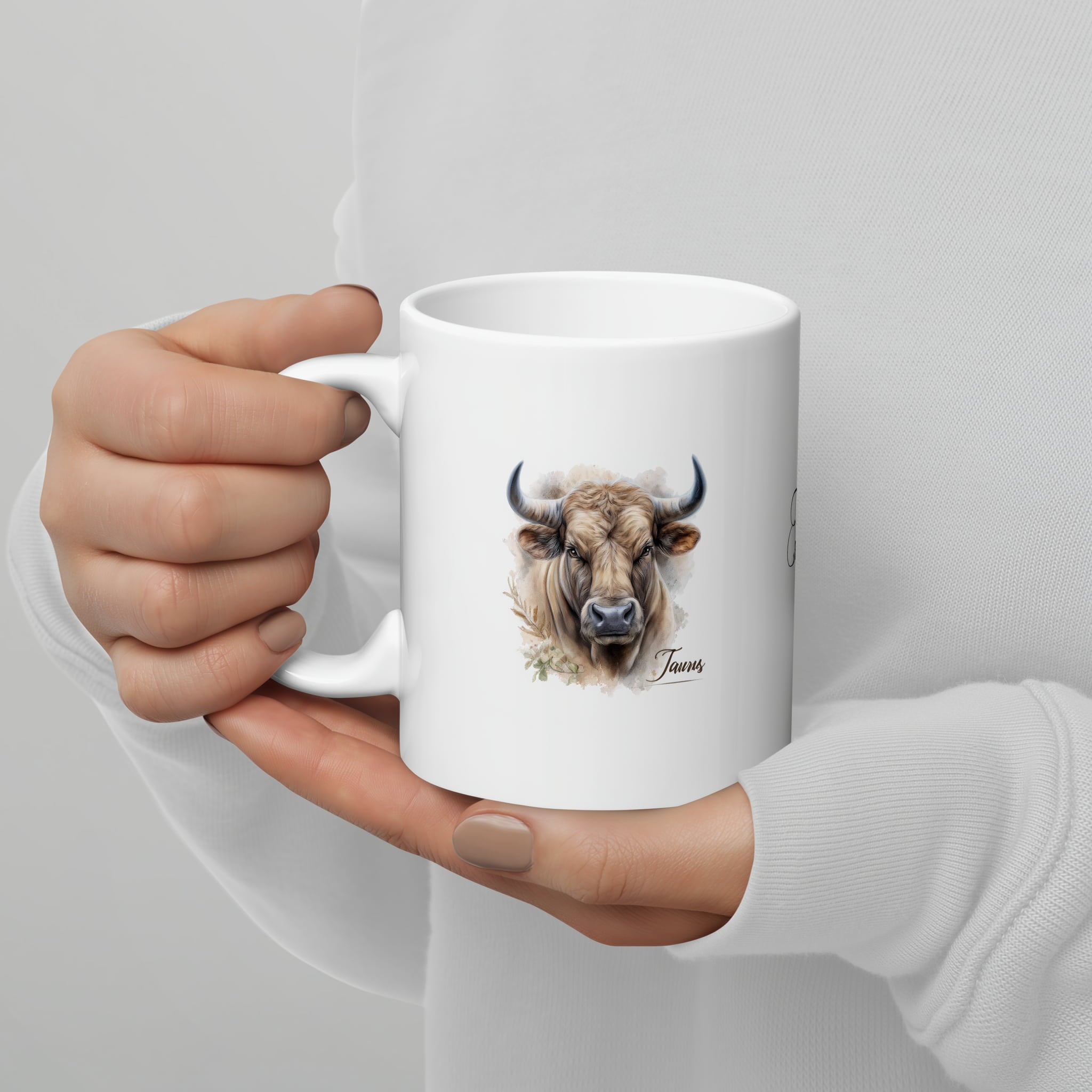 A stylized ceramic mug with a bold Taurus symbol on it. It hints at a thoughtful lifestyle choice reflecting the user's zodiac sign