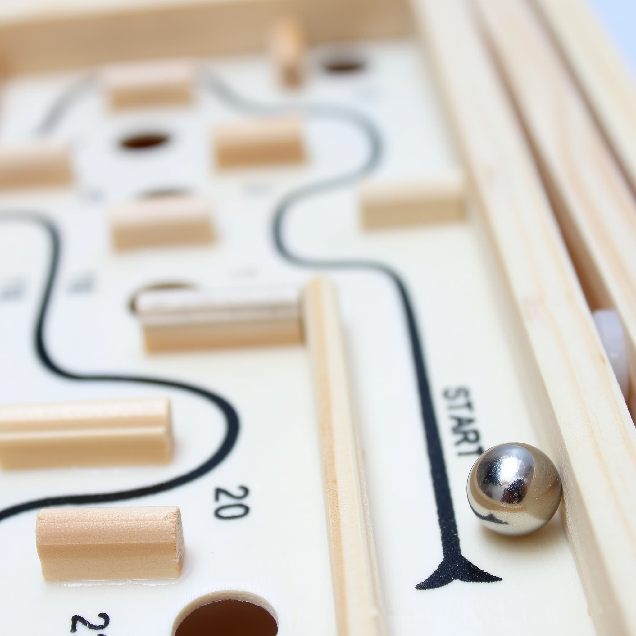 Close-up of oversized wooden maze balance game