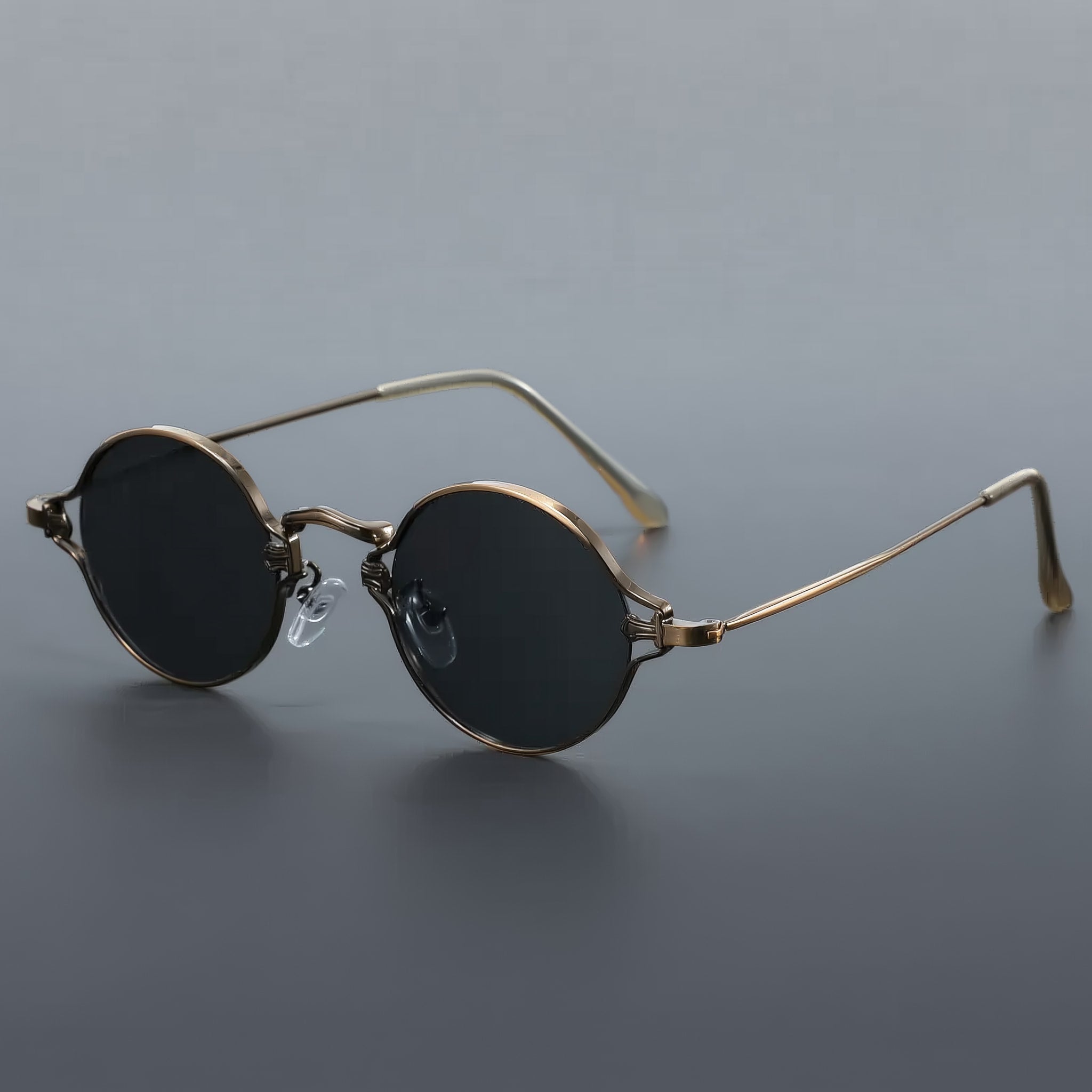 Vintage style round sunglasses with brushed bronze frame and gray lenses